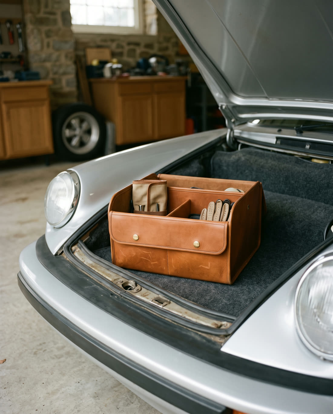 Leather trunk organiser in the front trunk of a classic silver sports car